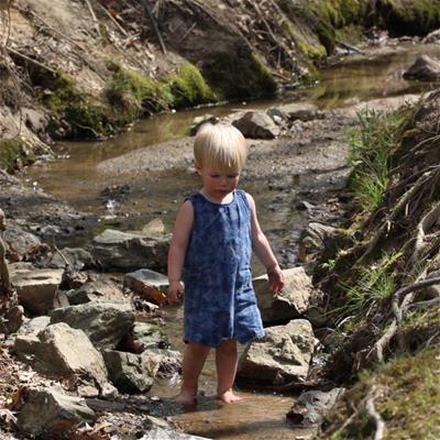 Small child standing in creek