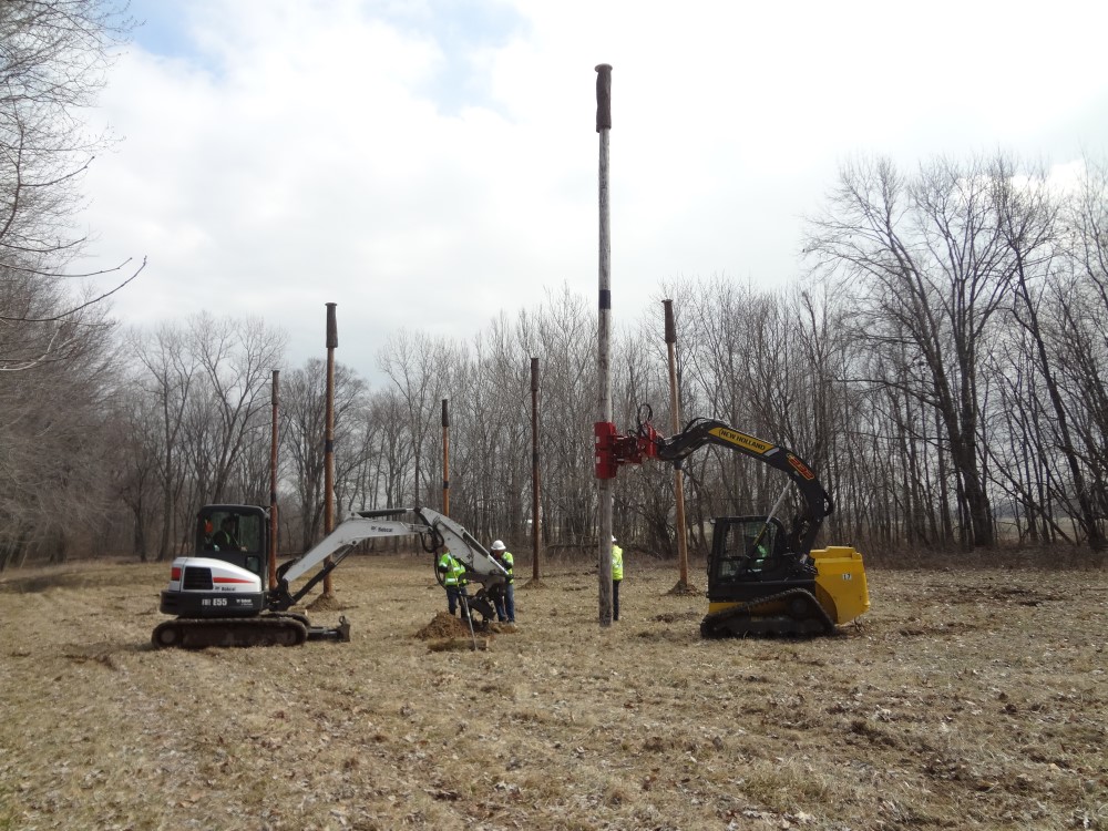 People installing roosting structures for bats