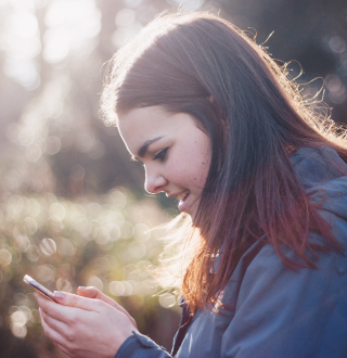 Young woman standing with phone