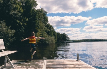 boy jumping off dock_pexels