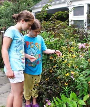 Kit's girl's looking at flowers