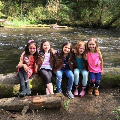 Girl Scouts sitting by a stream